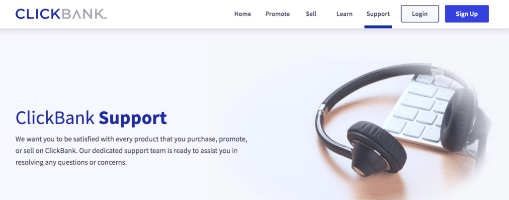 ClickBank's support page displays black headphones and a white keyboard.