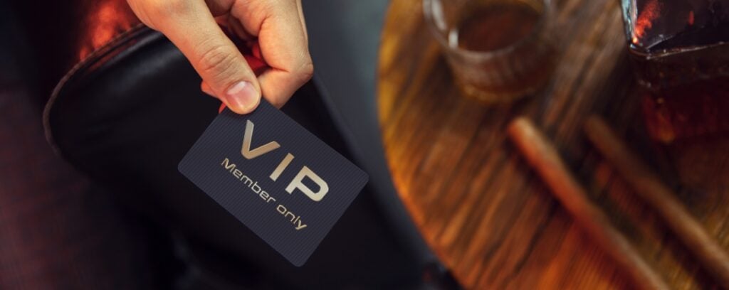 Subscription model - VIP member handing over membership card